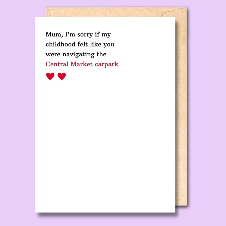 A plain white card that says "I'm sorry if my childhood felt like you were navigating the Central Market carpark" on the front.