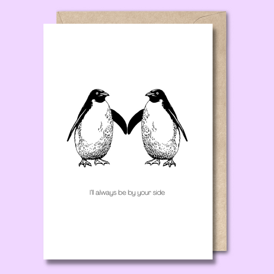 Front of a plain white greeting card with two penguins facing each other with their wings touching. The text below the image says "I’ll always be by your side."