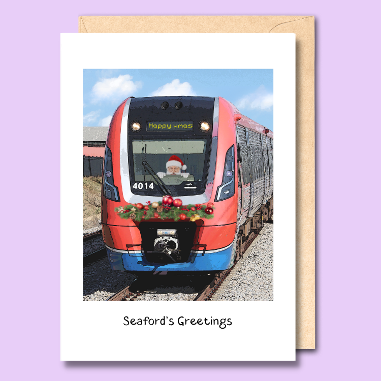 Greeting card with a stylised image of an Adelaide metro train on it. Santa is driving the train and the LED display says happy xmas. The text says “Seaton’s Greetings.”