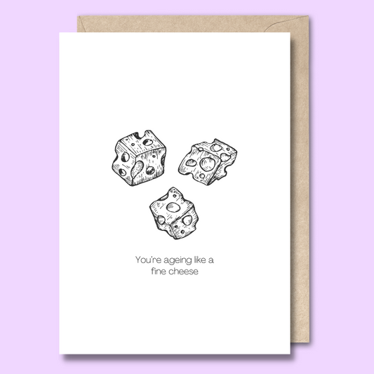 Front of a plain white greeting card with three black and white sketched pieces of swiss cheese in the middle. The text below the image says "You’re ageing like a fine cheese."