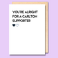 A white greeting card that says 'You're alright for a Carlton supporter' on the front.