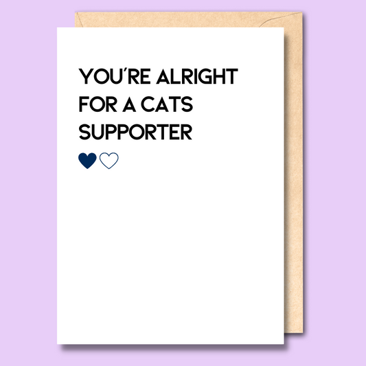 A white greeting card that says 'You're alright for a Cats supporter'