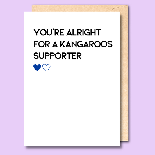 A white greeting card that says 'You're alright for a Kangaroos supporter'