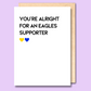 A white greeting card that says 'You're alright for an Eagles supporter'