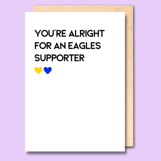 A white greeting card that says 'You're alright for an Eagles supporter'