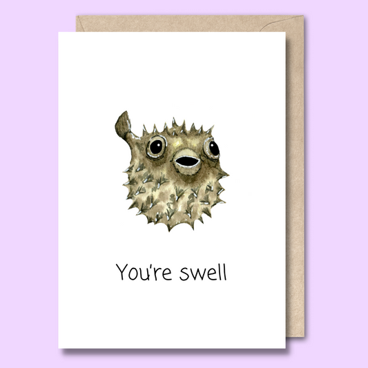 Greeting card with a watercolour style puffer fish on the front. The text says “You’re swell”