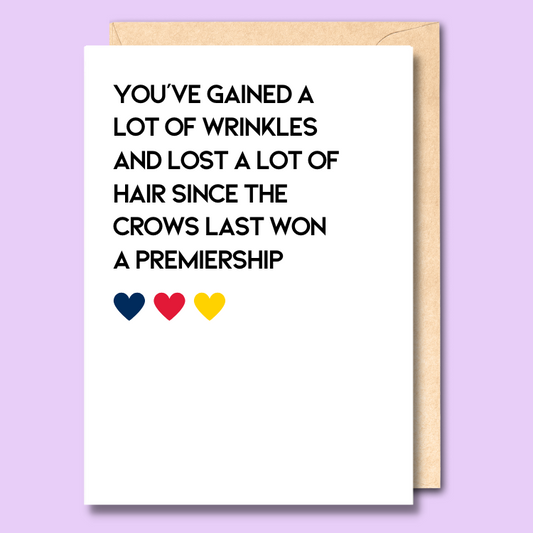 Greeting card with text on the front that says “You're gained a lot of wrinkles and lost a lot of hair since the crows last won a premiership"