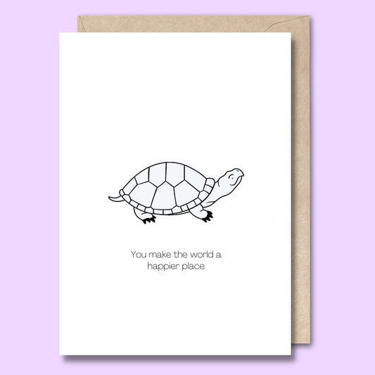 Front of a plain white greeting card with a sketch of a happy black and grey turtle in the middle. The text below the image says "You make the world a happier place."