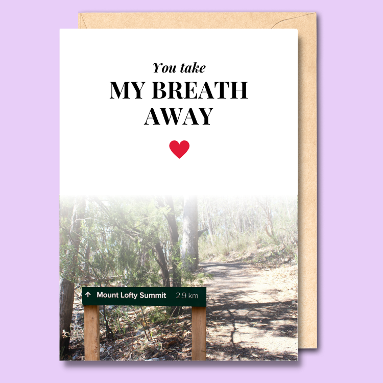 A white greeting card with a sign to Mount Lofty Summit on it. The text says "You take my breath away".