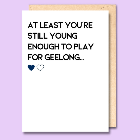 A white greeting card that says 'At least you're still young enough to play for Geelong'