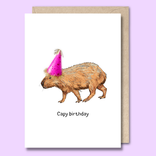 Greeting card with an image of a capybara on the front wearing a party hat. The text says “Capy birthday.”
