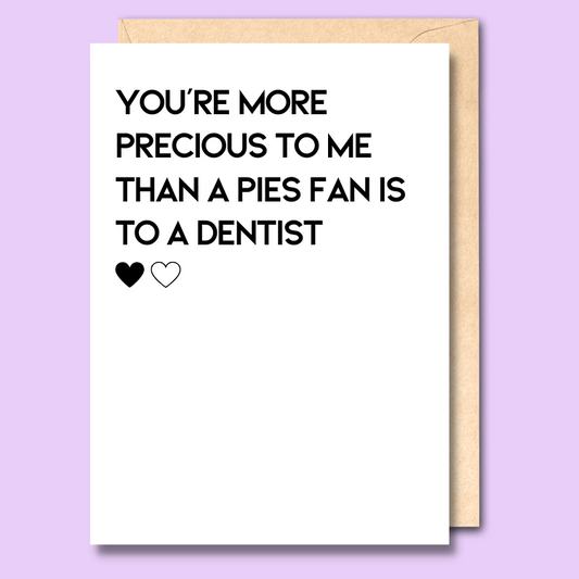 A white greeting card that says 'You’re more precious to me than a pies fan is to a dentist'
